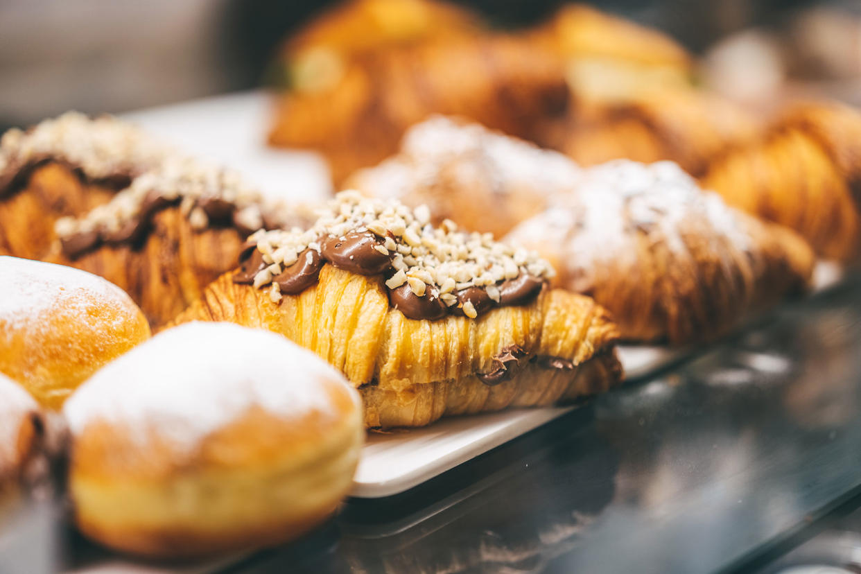 Homemade flaky pastry dough croissants, moist donuts, and buns with various flavored fillings Getty Images/Yana Iskayeva