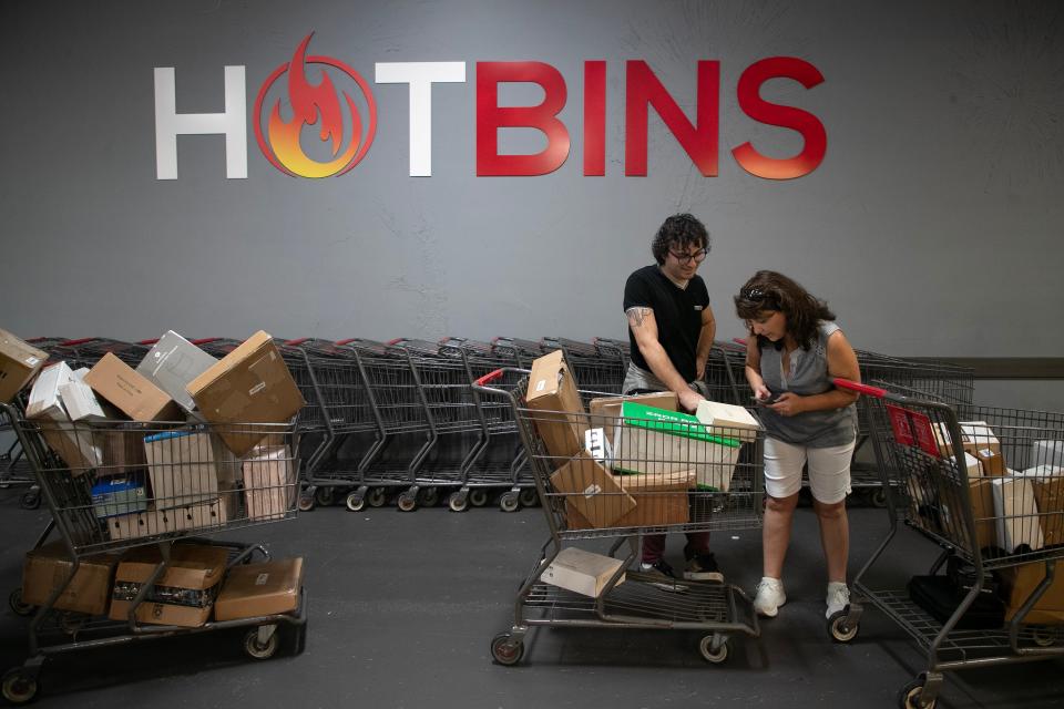 Tina Markowitz and her son Ryan wait in the unboxing line at Hotbins on Friday, Aug. 11, 2023, in Fort Myers. Customers can have four boxes at a time opened to see what is inside and to see the condition of the items.