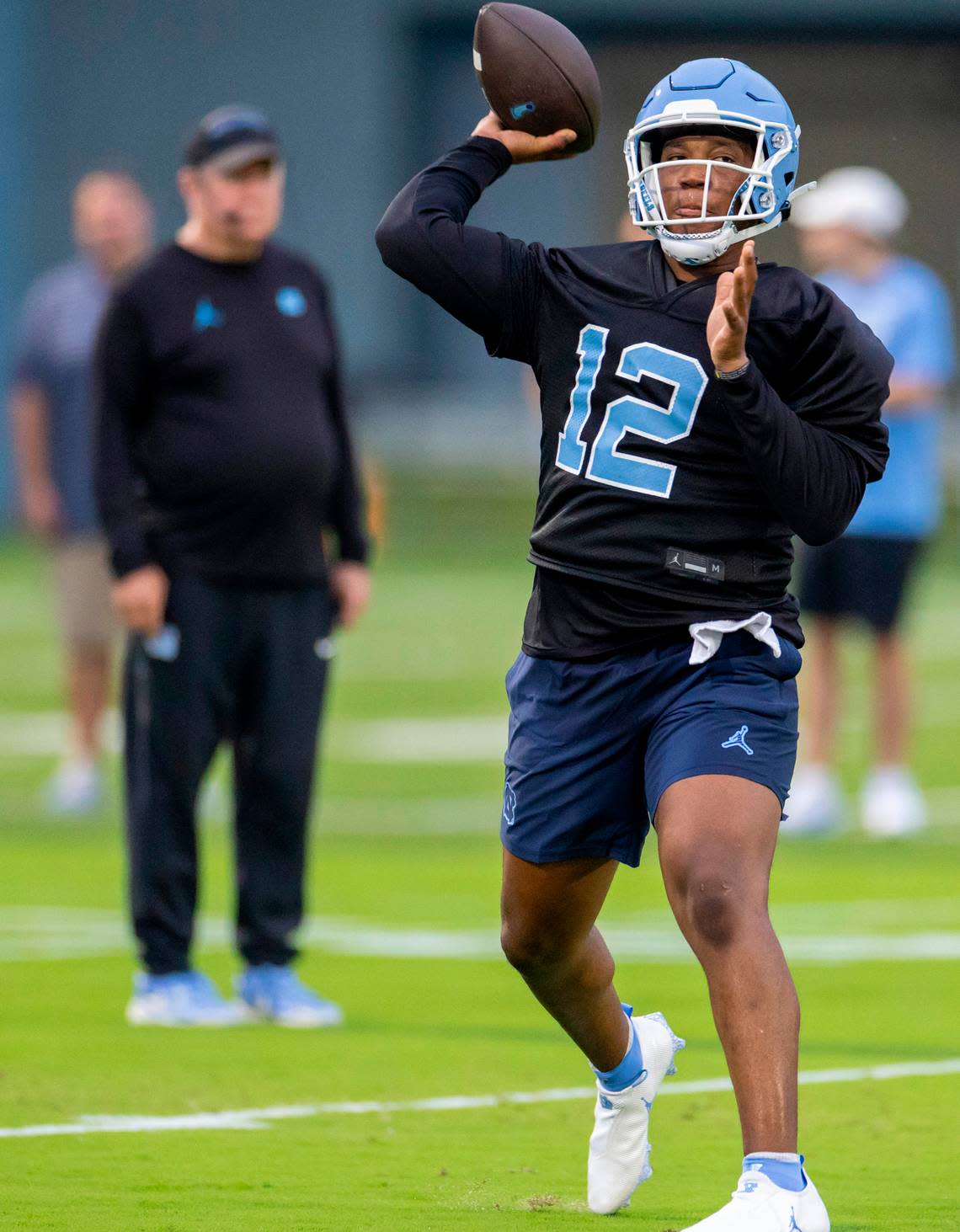 North Carolina coach Mack Brown watches graduate transfer quarterback Jacolby Criswell (12) during the Tar Heels’ first practice of the season on Monday, July 29, 2024 in Chapel Hill, N.C.