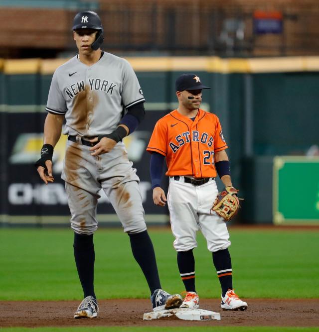 Photo: Jose Altuve stands while Yankees Aaron Judge celebrates in