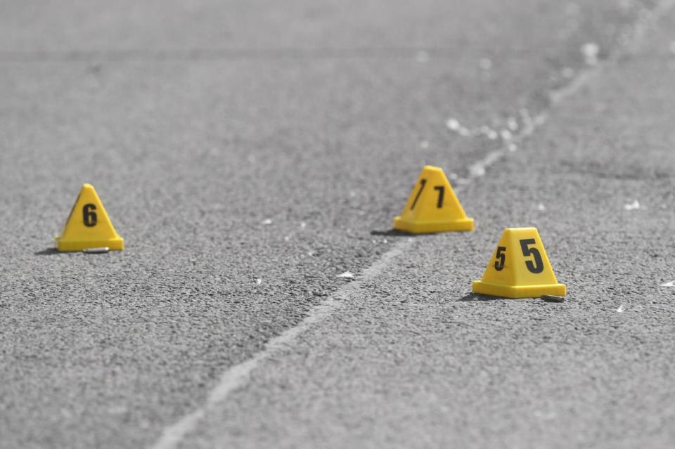 Scene: Evidence markers placed next to cartridges as forensic officers investigate (PA)