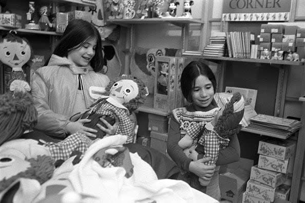 Little girls hold Raggedy Ann dolls in the children's section at Macy's department store in the Christmas season (Photo by Fairchild Archive/Penske Media via Getty Images)
