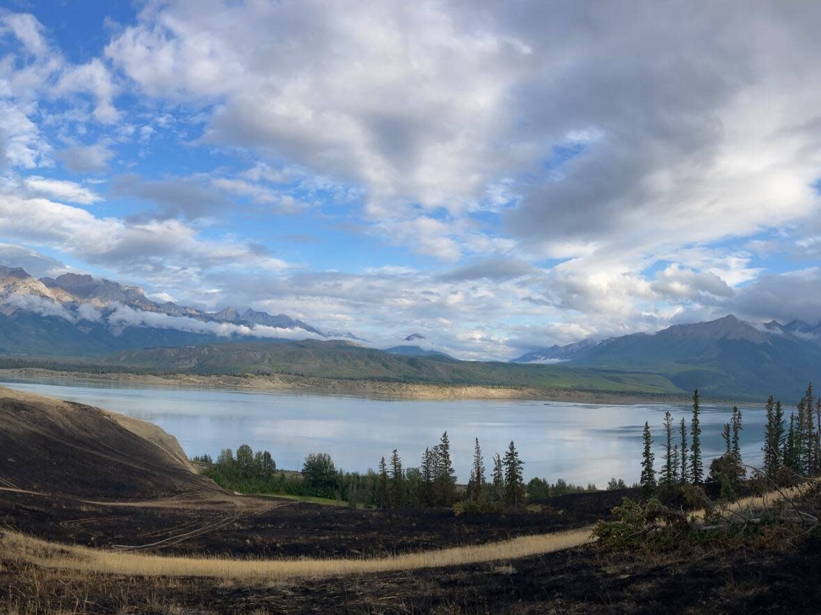 Parks Canada has deemed the wildfire on Chetamon Moutain, in Jasper National Park, as being held. The agency does not expect it to grow bigger than its estimated size of 6,000 hectares. (Submitted by Parks Canada - image credit)