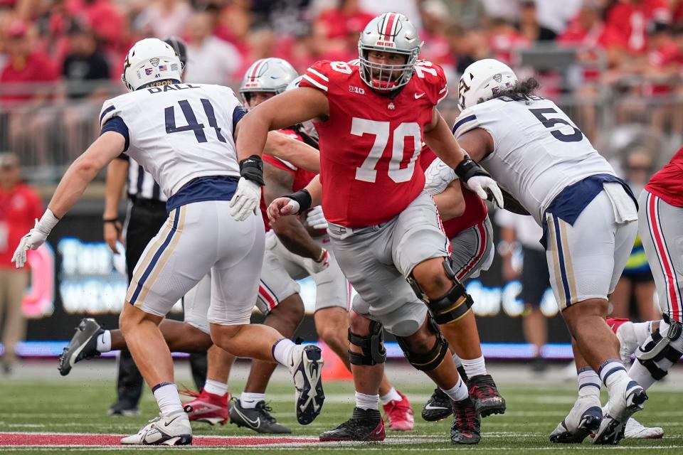 Aug 31, 2024; Columbus, OH, USA; Ohio State Buckeyes offensive lineman Josh Fryar (70) leads the block during the NCAA football game against the Akron Zips at Ohio Stadium. Ohio State won 52-6.