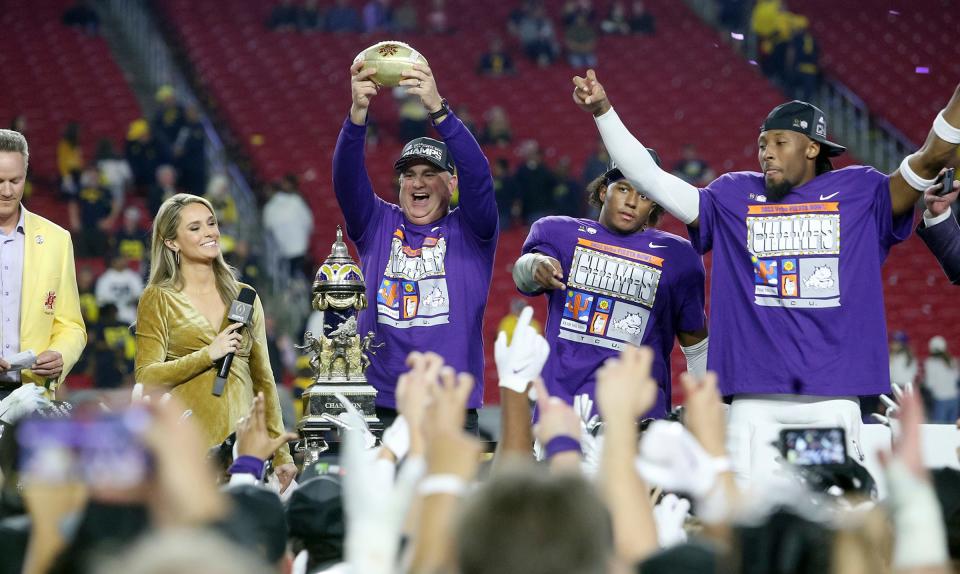 TCU coach Sonny Dykes holds up the Fiesta Bowl trophy after the team's win over Michigan in the Fiesta Bowl NCAA college football game in Glendale, Ariz., Saturday, Dec. 31, 2022. TCU advanced to the College Football Playoff national championship.