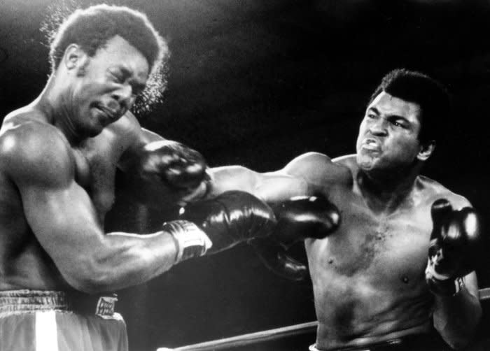 Muhammad Ali (R) rocks George Foreman with a hard right during their heavyweight title bout on October 30, 1974, in Kinshasa, Zaire. Ali knocked Foreman out in the 8th round to regain his heavyweight crown. File Photo by Mike Feldman/UPI