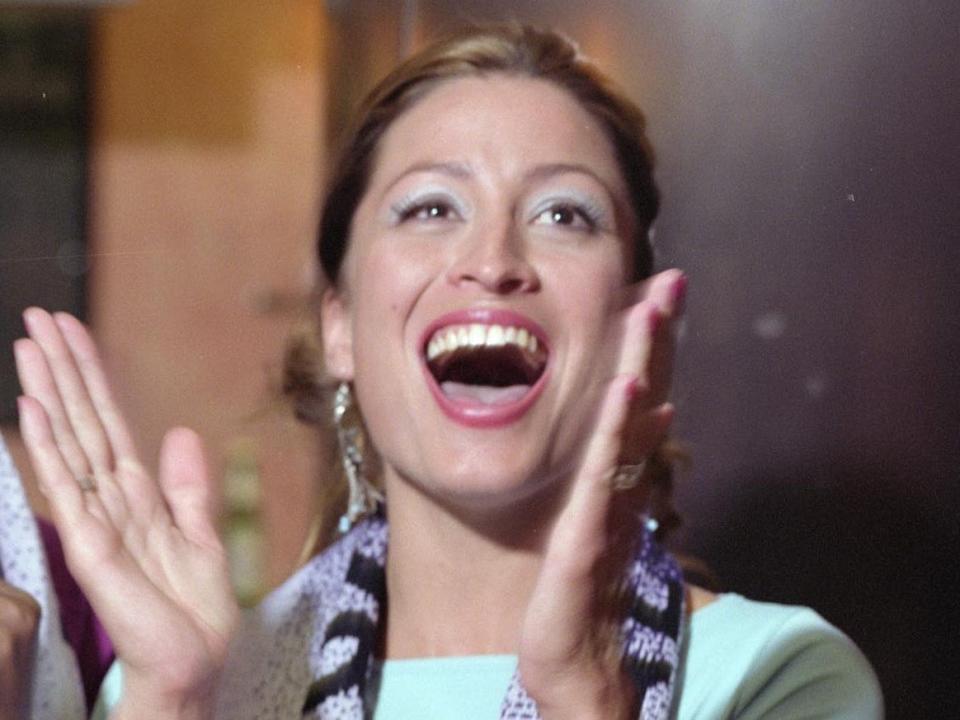 Rebecca Loos laughing and holding her hands as if she's about to clap.