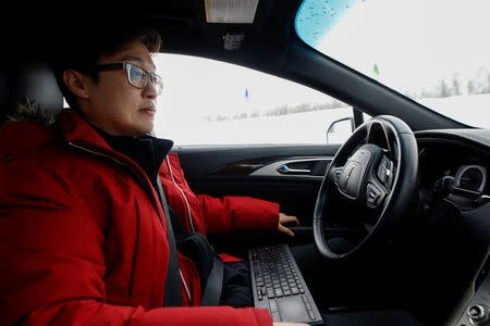 Software engineer Steven Han demonstrates a self-driving car at the Renesas Electronics autonomous vehicle test track in Stratford, Ontario, Canada, March 7, 2018. REUTERS/Mark Blinch