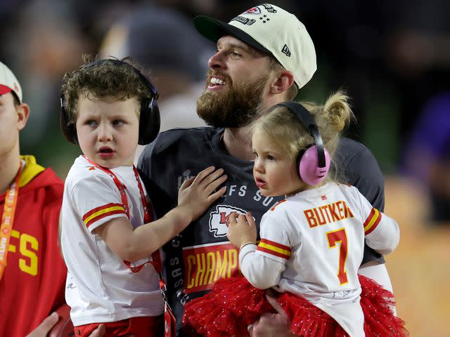 <p>Carmen Mandato/Getty </p> Harrison Butker celebrates with his children after kicking the go ahead field goal to beat the Philadelphia Eagles in Super Bowl LVII on February 12, 2023 in Glendale, Arizona.