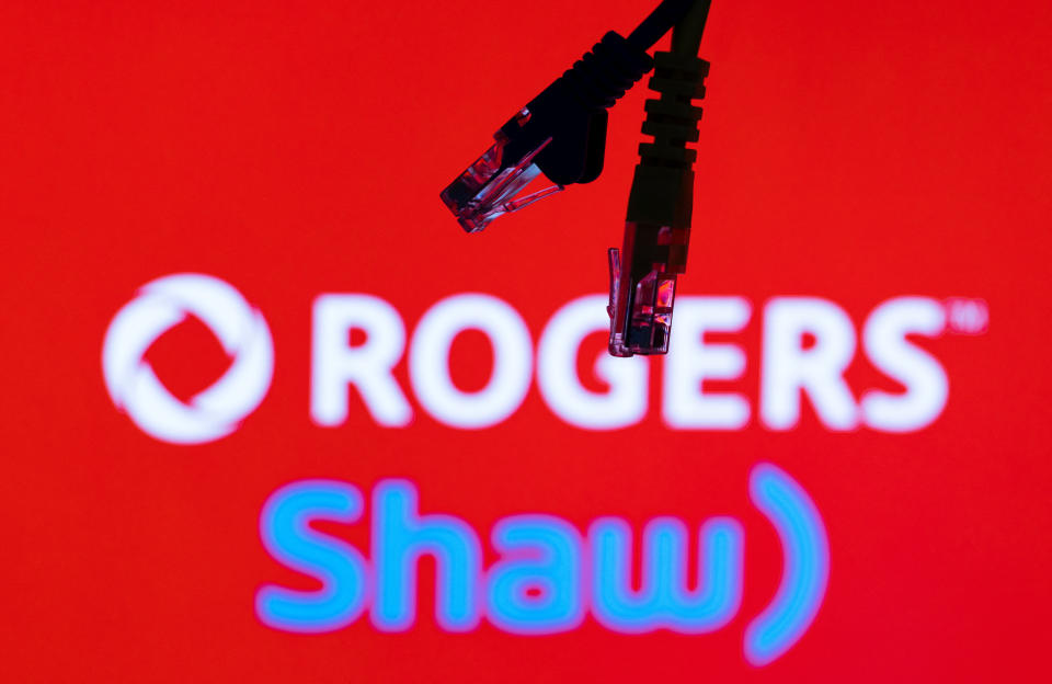 Ethernet cables are seen in front of Rogers and Shaw Communications logos in this illustration taken, July 8, 2022. REUTERS/Dado Ruvic/Illustrations