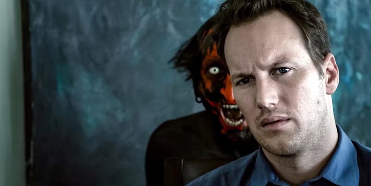 a red faced demon stands behind a man in a scene from the insidious franchise