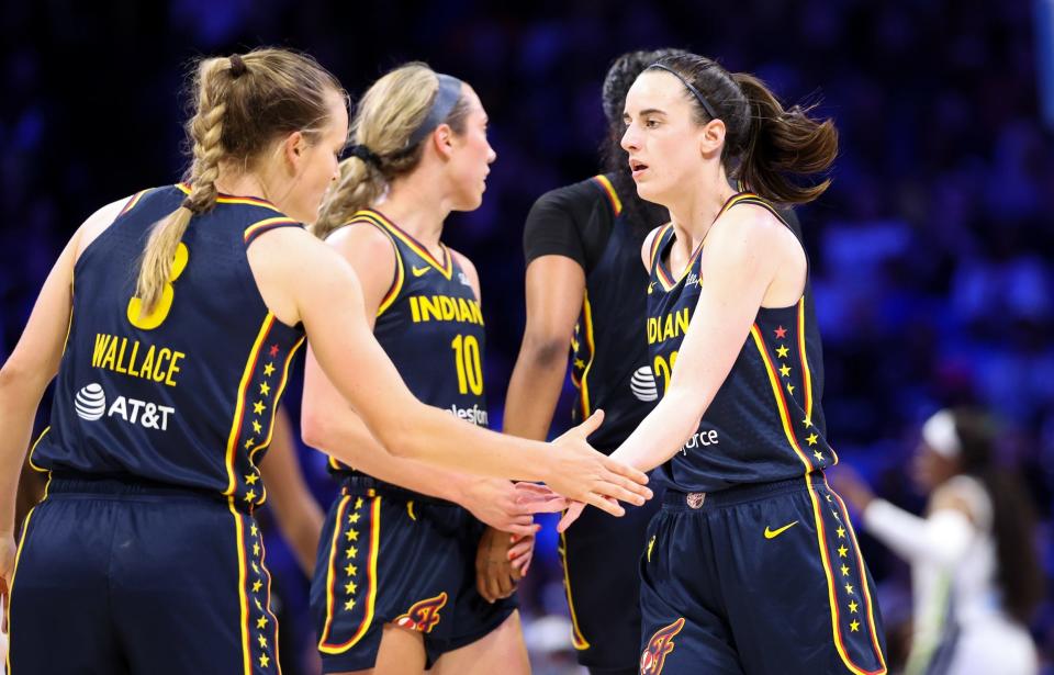 Indiana Fever guard Caitlin Clark (22) celebrates with Indiana Fever guard Kristy Wallace (3) during a preseason game against the Dallas Wings on May 3.