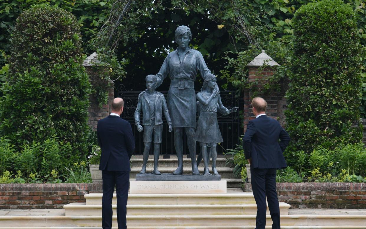 Prince William, Duke of Cambridge (left) and Prince Harry, Duke of Sussex look at a statue they commissioned of their mother Diana, Princess of Wales, in the Sunken Garden at Kensington Palace, on what would have been her 60th birthday on July 1, 2021 in London, - Getty 