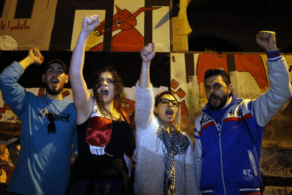 Protesters chant slogans during ongoing protests against the Lebanese political class, in downtown Beirut, Lebanon, Sunday, Dec. 22, 2019. Lebanon's new prime minister held consultations Saturday with parliamentary blocs in which they discussed the shape of the future government. The next administration will have to steer the country out of its worst economic and financial crisis in decades. (AP Photo/Bilal Hussein)