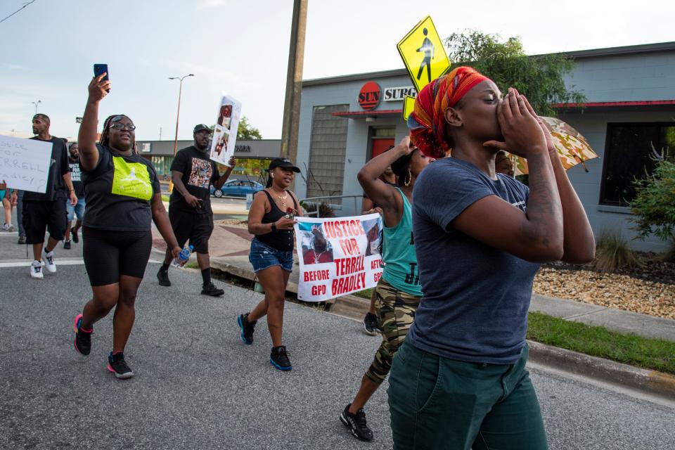 Protestors march down Northwest Sixth Street during a protest for Terrell Bradley in Gainesville, Fla., on Sunday, July 17, 2022.