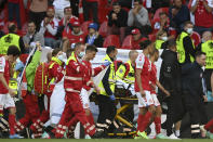 Denmark's Christian Eriksen is taken away on a stretcher after collapsing on the pitch during the Euro 2020 soccer championship group B match between Denmark and Finland at Parken Stadium in Copenhagen, Saturday, June 12, 2021. (Stuart Franklin/Pool via AP)