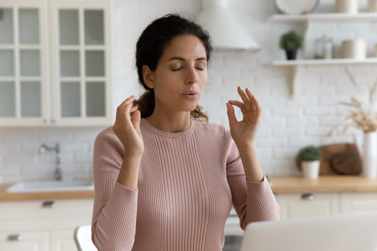 Woman breathing through her stress. (Getty Images)