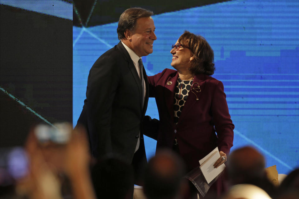 Panama's President Juan Carlos Varela, left, greets Iberoamerican Secretary Rebeca Grynspan during an economic forum as part the XXVI Iberoamerican Summit in Antigua, Guatemala, Thursday, Nov. 15, 2018. The event is a biennial two-day meeting of heads of state from Latin America and the Iberian Peninsula. (AP Photo/Moises Castillo)