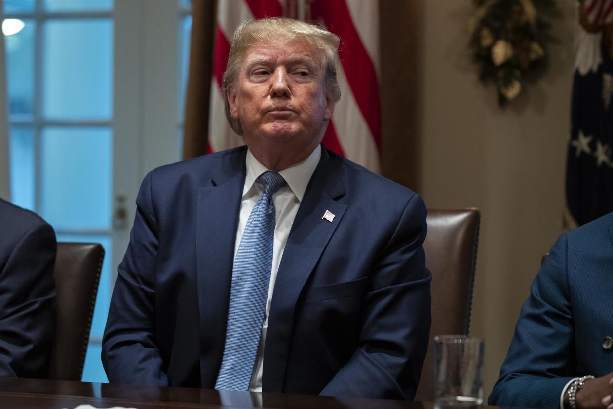 Donald Trump listens during a roundtable in the Cabinet Room of the White House on Monday. A government report has found that the FBI's Russia probe was not motivated by political bias against the president: AP