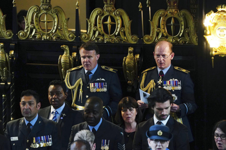 Chief of the Air Staff, Air Chief Marshal Sir Mike Wigston, background right, attends the funeral service of former RAF Sergeant Peter Brown, at St Clement Danes Church, in London, Thursday May 25, 2023. Jamaican Flight Sgt. Peter Brown who flew bombing missions in World War II after volunteering for the Royal Air Force died in December, aged 96. Volunteers tried to track down family and people who knew him. Word of that search drew interest from others who didn't want him to be forgotten for the service he offered in Britain's darkest hour. (Victoria Jones/PA via AP)