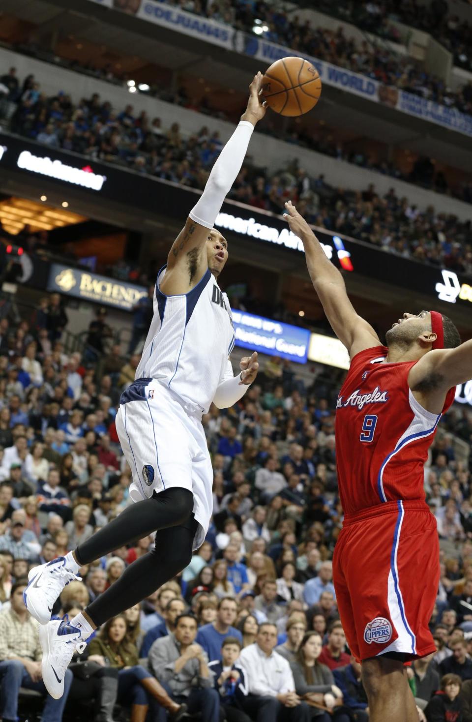 Dallas Mavericks forward Shawn Marion (0) take a shot over Los Angeles Clippers forward Jared Dudley (9) during the second half of an NBA basketball game Friday, Jan. 3, 2014, in Dallas. The Clippers won 119-112. (AP Photo/Sharon Ellman)