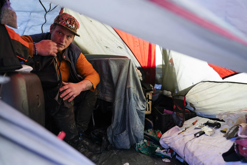 Dylan Miner sits inside his tent in San Francisco, Monday, Dec. 12, 2022. (AP Photo/Godofredo A. Vásquez)