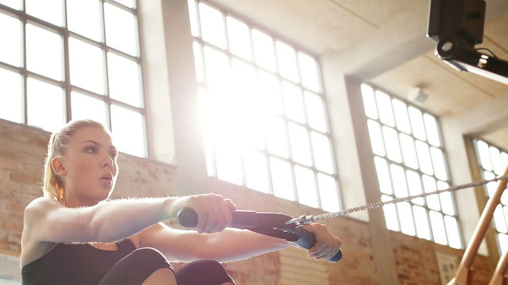 is rowing good cardio? woman using an indoor rowing machine as cardio exercise