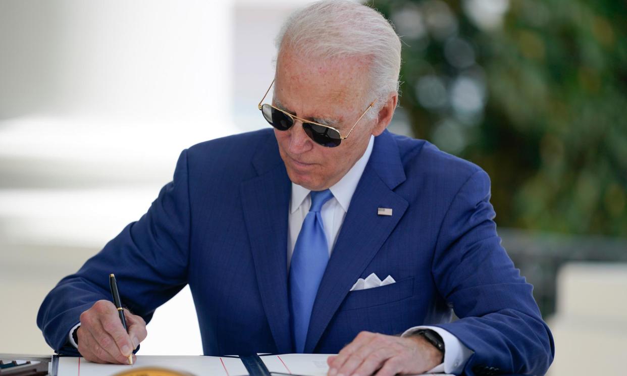 <span>President Joe Biden signs two bills aimed at combating fraud in the Covid small business relief programs on 5 August 2022.</span><span>Photograph: Getty Images</span>