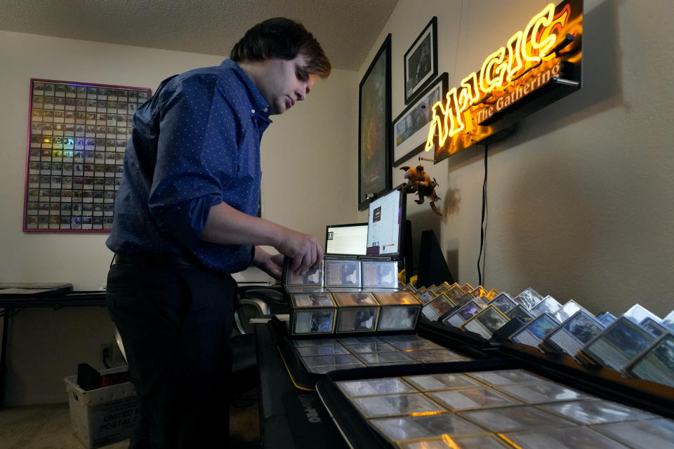 Austin Deceder sorts Magic cards in his home office Friday, Aug. 27, 2021, in Kansas City, Mo. Prices of the collectable cards and vintage video games that Deceder and others buy and sell have skyrocketed in the past few months to the dismay of hobbyists. (AP Photo/Charlie Riedel)