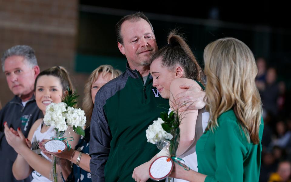 Williamston's Kenzie Lewis gets a hug from dad, Tom, during a senior day ceremony following a game against Haslett, Feb. 21, 2020, in Williamston.