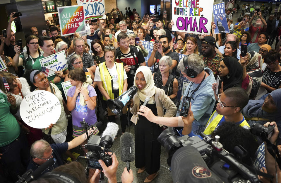 U.S. Rep. Ilhan Omar speaks to supporters after arriving home, at Minneapolis–Saint Paul International Airport, Thursday, July 18, 2019, in Minnesota. President Donald Trump is chiding campaign supporters who'd chanted "send her back" about Somali-born Omar, whose loyalty he's challenged. (Glen Stubbe/Star Tribune via AP)