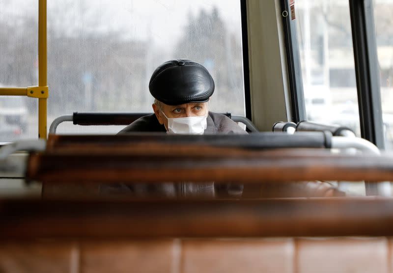 FILE PHOTO: A passenger wearing a protective mask sits inside a bus in Stavropol