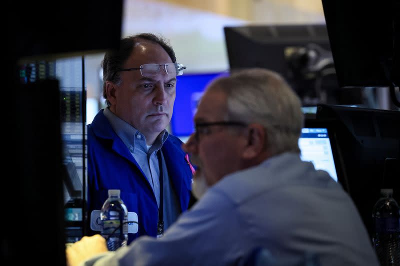 Traders work on the floor of the NYSE in New York