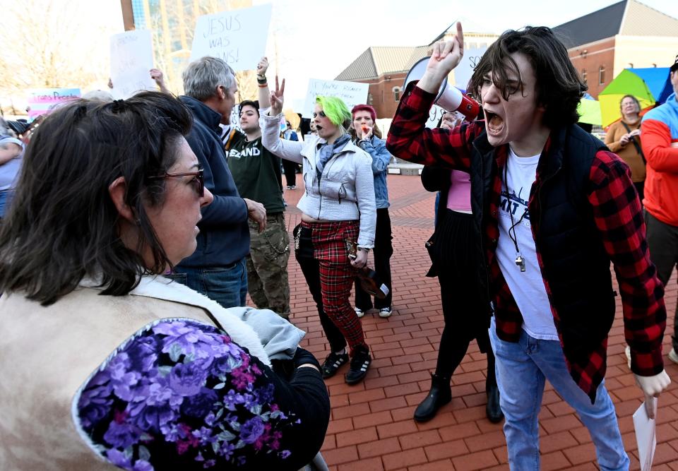 Aiden Pratt, 15, a supporter of the Rainbow Rutherford and BoroPride groups shouts at a woman with the Teens Against Transgender Mutilation on Saturday, Jan. 28, 2023, in Murfreesboro, Tenn. Gay right supporters are upset the city approved a permit the group to have its rally.