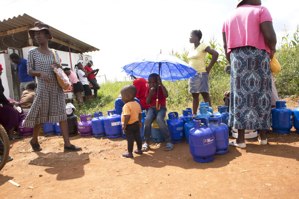 People queue for cooking gas in Harare, Zimbabwe, Sunday, March 29, 2020. Zimbabwean President Emmerson Mnangagwa announced a nationwide lockdown for 21 days, starting March 30,in an effort to stop the spread of the Covid-19 pandemic. The COVID-19 coronavirus causes less serious symptoms for most people, but for some, especially older adults and people with existing health problems, it can cause severe illness and even death. (AP Photo/Tsvangirayi Mukwazhi)