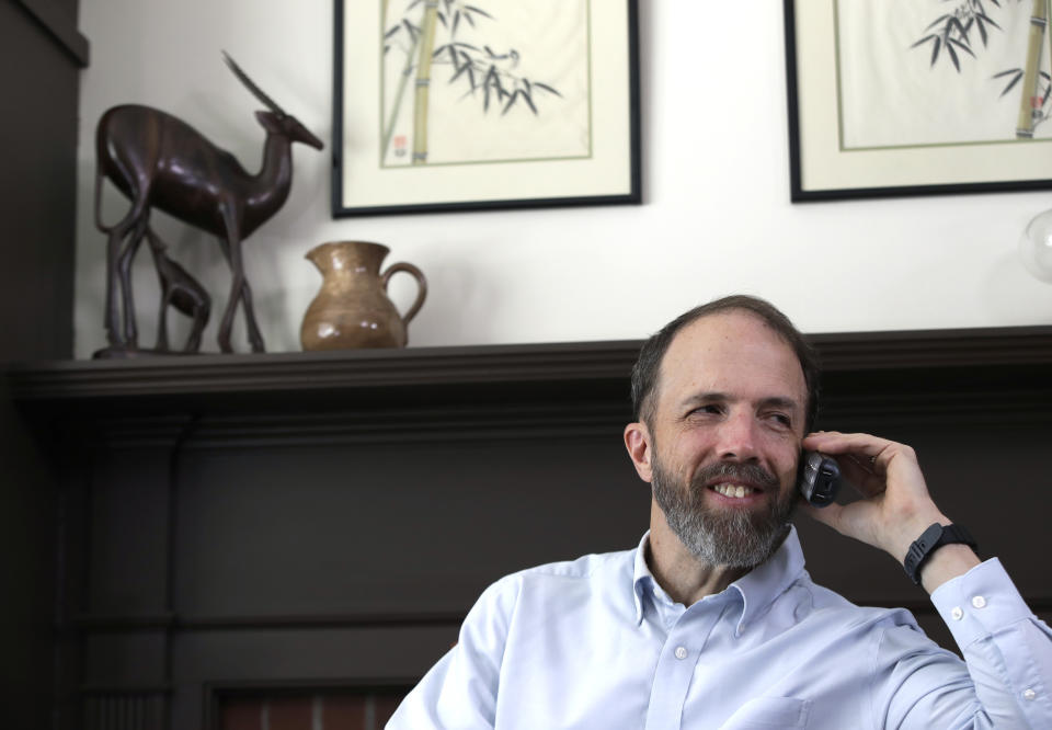 In this Jan. 30, 2019 photo, Dr. Rick Sacra speaks to a reporter by phone at his Holden, Mass. home. Sacra, a Massachusetts doctor who was among a handful of Americans treated and cured of Ebola in 2014, is being honored for his work in Liberia through the deadly epidemic. (AP Photo/Elise Amendola)