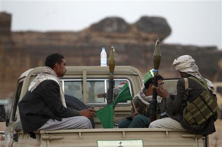 Armed followers of Yemen's Shi'ite Houthi group sit on a truck patrolling the vicinity of a ceremony attended by fellow Shi'ites in Dhahian of the northwestern Yemeni province of Saada February 3, 2012. REUTERS/Khaled Abdullah
