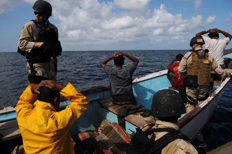 Teams from the U.S. Navy and Coast Guard secure the crew members of a vessel during a boarding in 2009.