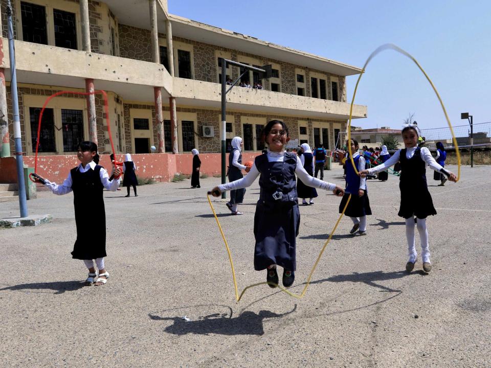 Iraqi girls play at a yard of a school in Mosul, Iraq: Reuters