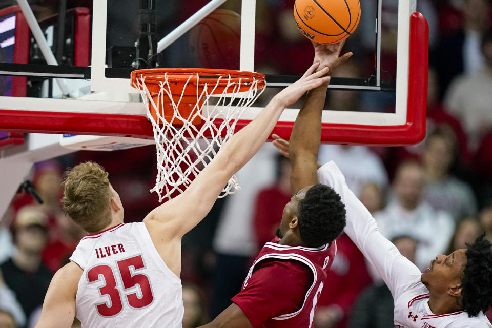 Indiana's Xavier Johnson (0) shoots between Wisconsin's Markus Ilver (35) and Kamari McGee during the second half of an NCAA college basketball game Friday, Jan. 19, 2024, in Madison, Wis. (AP Photo/Andy Manis)