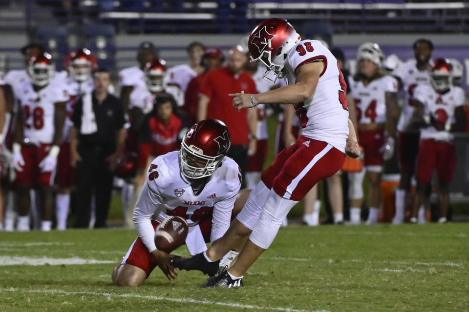 Miami (Ohio) place kicker Graham Nicholson (98) kicks the game-winning field goal against Northwestern from the hold of Alec Bevelhimer during the second half of an NCAA college football game Saturday, Sept. 24, 2022, in Evanston, Ill. (AP Photo/Matt Marton)