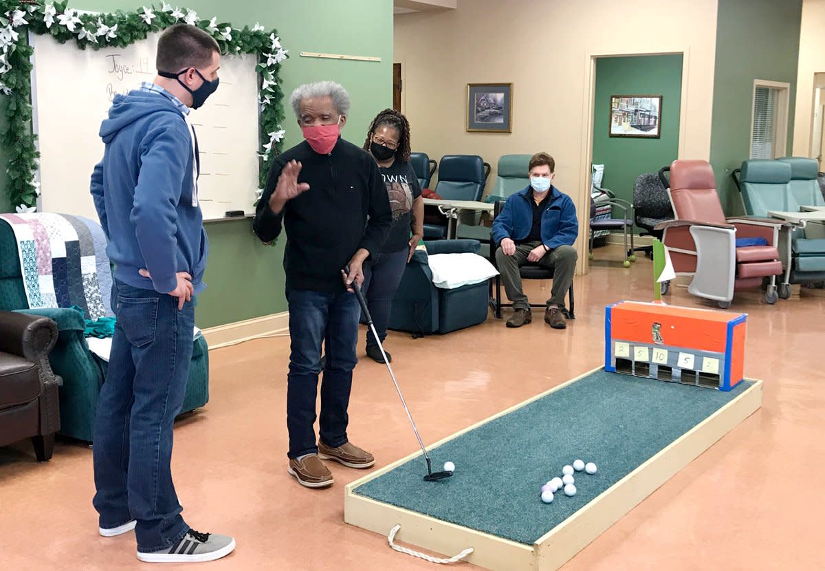 A group of people play games at a non-profit senior daycare center at a church.