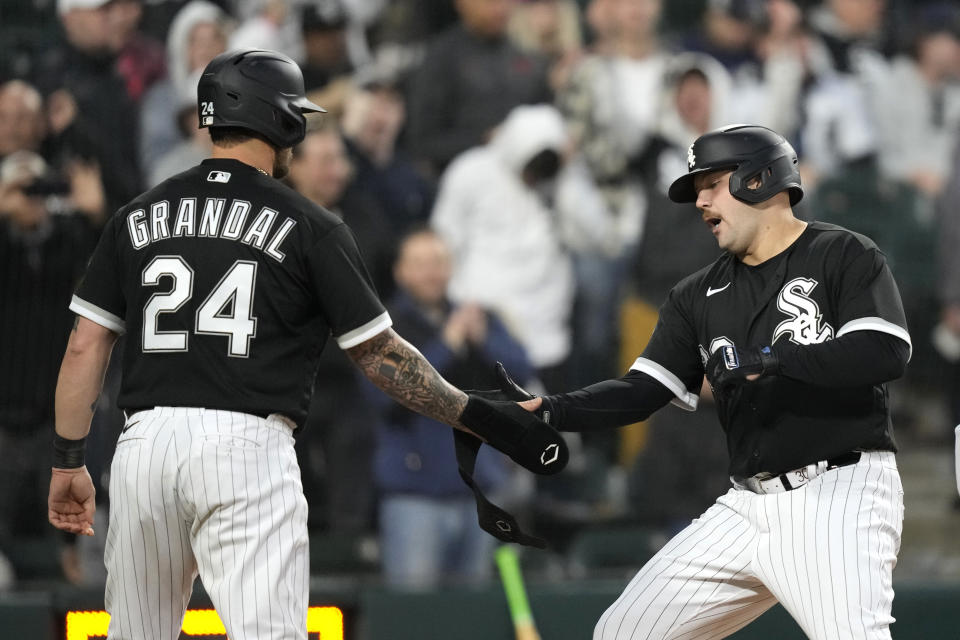 Chicago White Sox's Jake Burger, right, celebrates with Yasmani Grandal after they scored on Burger's two-run home run off Cleveland Guardians starting pitcher Peyton Battenfield during the fourth inning of a baseball game Wednesday, May 17, 2023, in Chicago. (AP Photo/Charles Rex Arbogast)