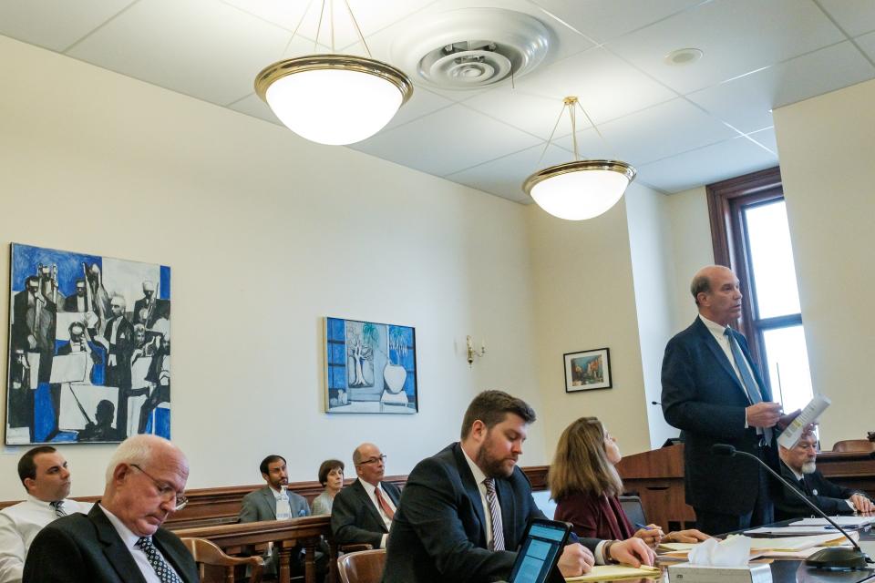 Jonathan Downes, the attorney representing former Dover Mayor Richard P. Homrighausen, at far right, addresses the court during a hearing in the lawsuit against the City of Dover and Law Director Douglas O'Meara, Monday, in the Tuscarawas Court of Common Pleas. Pictured from left, Dover Mayor Shane Gunnoe, Law Director Douglas O'Meara, Nick Homrighausen, Linda Homrighausen, attorney Mark DeVan, attorney Halden Shwalli, attorney Robin Wilson, attorney Jonathan Downes, and Richard Homrighausen.