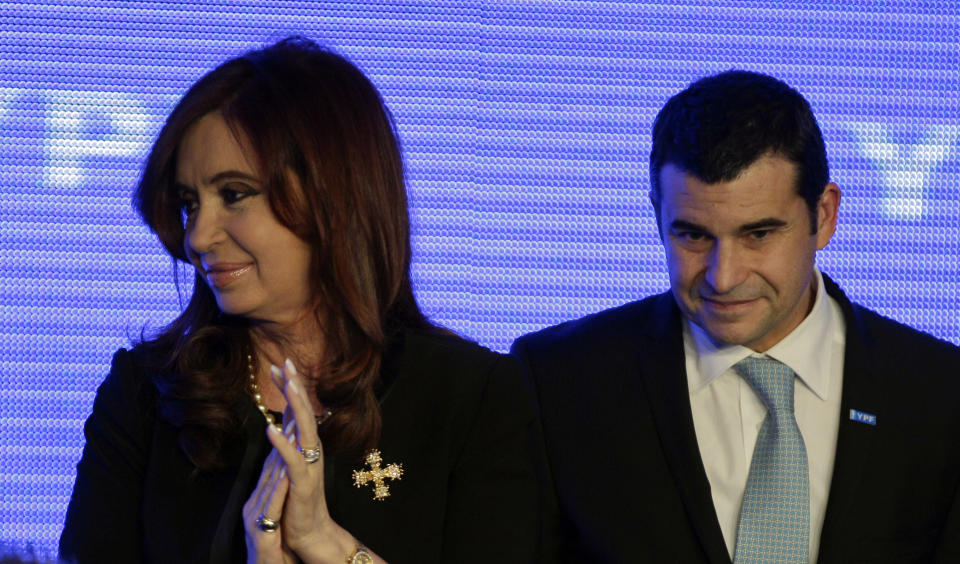 Argentina's President Cristina Fernandez, left, and YPF's General Manager Miguel Gallucio smile during a ceremony to announce new investments in YPF in Buenos Aires, Argentina, Tuesday, June 5, 2012. Galuccio announced a five-year plan that includes an investment of up to $7 billion annually to expand exploration and boost production. (AP Photo/Natacha Pisarenko)