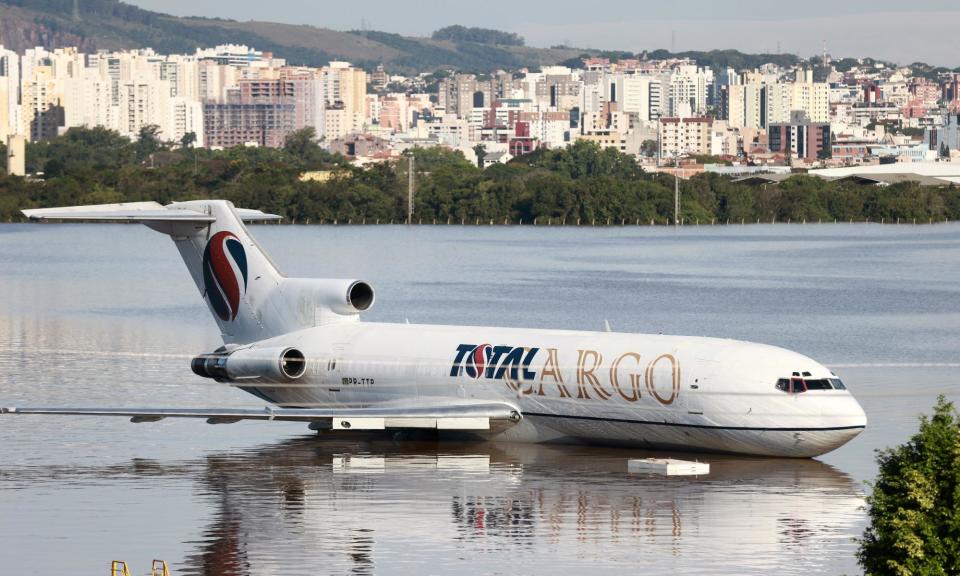 <span>A cargo plane sits on a flooded runway at the airport in Porto Alegre, Rio Grande do Sul, Brazil, on 6 May 2024.</span><span>Photograph: Diego Vara/Reuters</span>