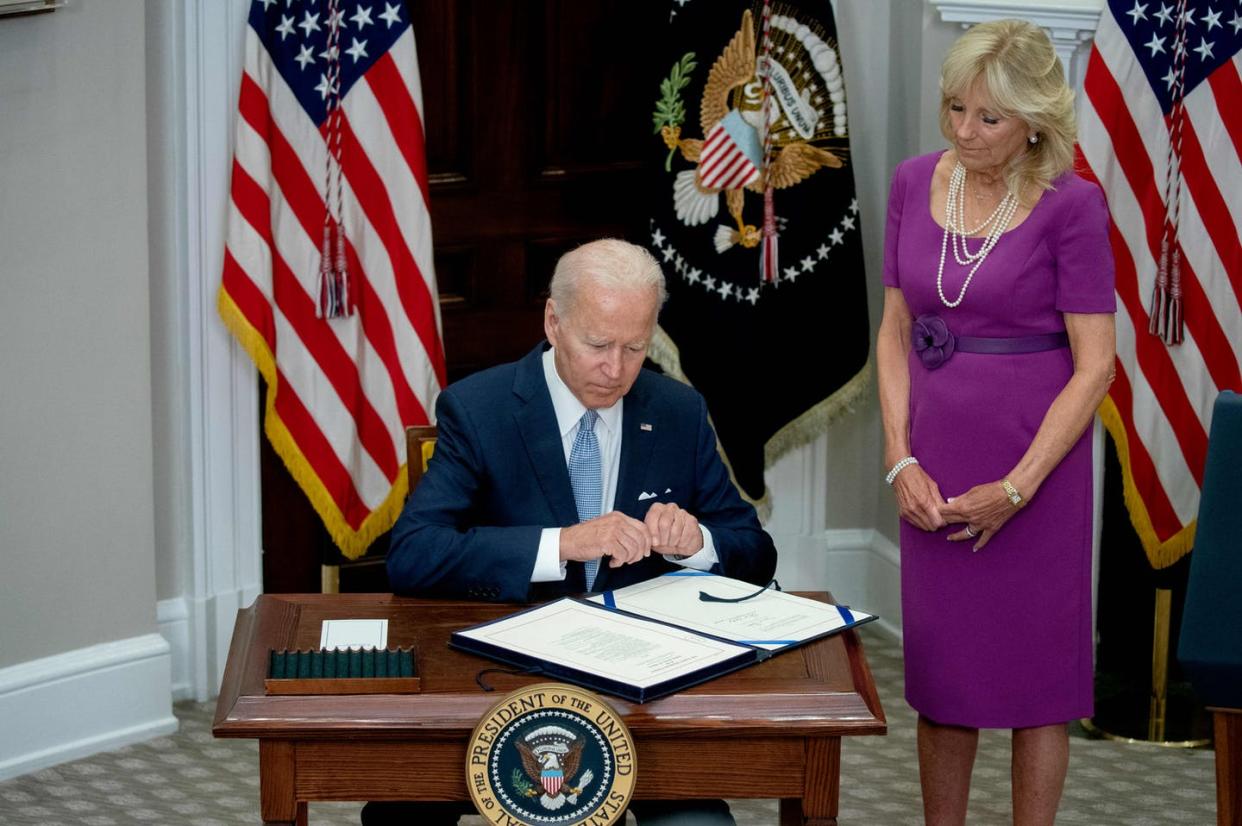 <span class="caption">President Joe Biden signs the Bipartisan Safer Communities Act into law.</span> <span class="attribution"><a class="link " href="https://www.gettyimages.com/detail/news-photo/first-lady-jill-biden-looks-on-as-us-president-joe-biden-news-photo/1241520942?adppopup=true" rel="nofollow noopener" target="_blank" data-ylk="slk:Stefani Reynolds/AFP via Getty Images;elm:context_link;itc:0;sec:content-canvas">Stefani Reynolds/AFP via Getty Images</a></span>