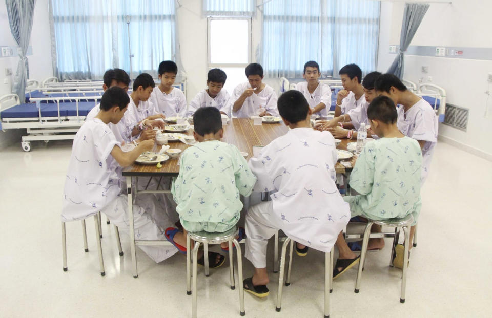 <em>Some of the rescued soccer team members eat a meal together at a hospital in Chiang Rai, northern Thailand (AP)</em>