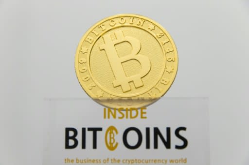 (FILES) This picture taken on January 17, 2018 shows a visual representation of the digital cryptocurrency Bitcoin, at La Maison du Bitcoin in Paris