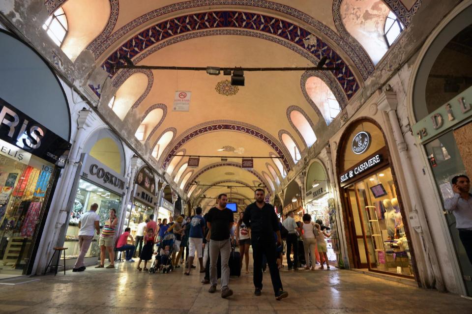FILE - In this Aug. 21, 2013 file photo, people walk inside the 15th century Grand Bazaar in Istanbul, Turkey. Last summer, Istanbul’s Taksim Square was the scene of violent confrontations between police and protesters. But protests have faded, and contrary to some lingering perceptions, it’s quite calm now _ except for the normal hustle and bustle found in this vibrant city. And it’s as safe for tourists as it ever was. Istanbul is a thoroughly modern place, but it traces its roots back to 660 B.C. It’s the former seat of the opulent Byzantine and Ottoman empires and is divided into European and Asian sides by the Bosporus Strait, offering a wealth of history and stunning scenery.(AP Photo/File)